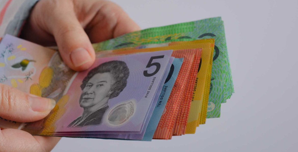 Hands holding Australian currency | Featured image for Managing Cashflow and Why It’s Important for Small Business blog by Go Figured Bookkeeping.